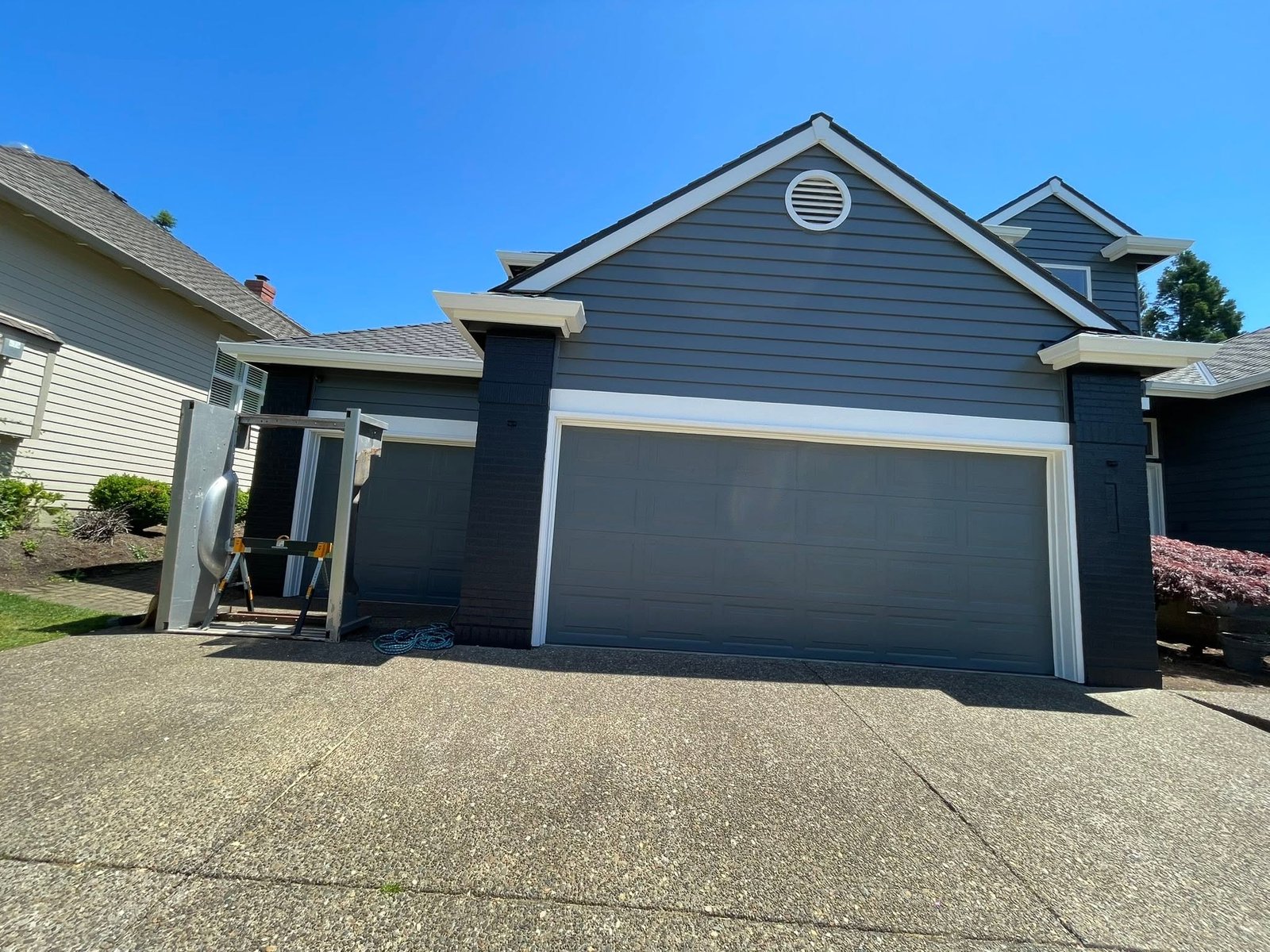 Freshly painted blue two-story home with bright white trim